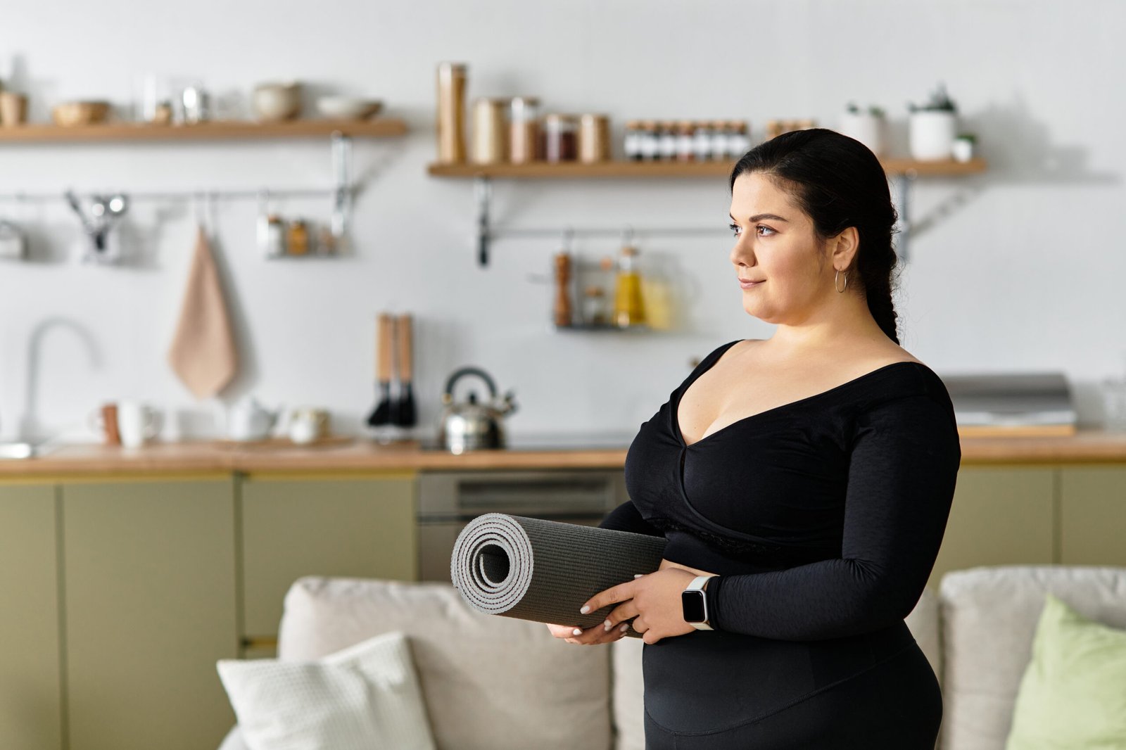 Woman holding an exercise mat at home